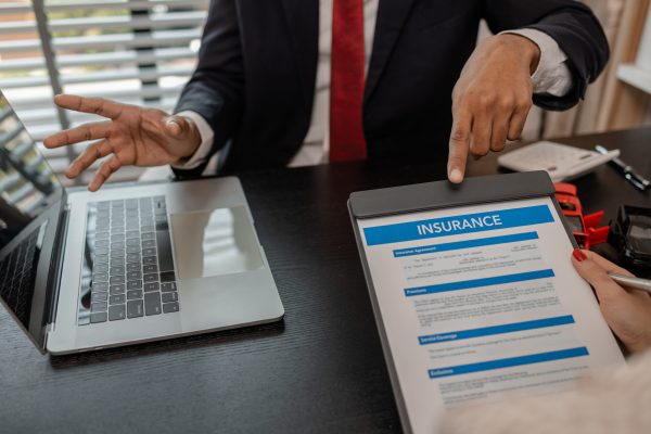 a lawyer explains the details of a car insurance policy and all the costs to a client, a lawyer explains to a client what will happen if she dose not have car insurance