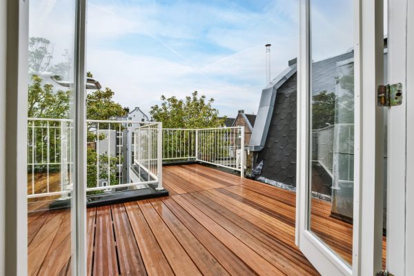 Rooftop exterior with delightful wood flooring and white railings